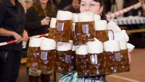 oktoberfest-waitress-serves-mugs-beer.jpg